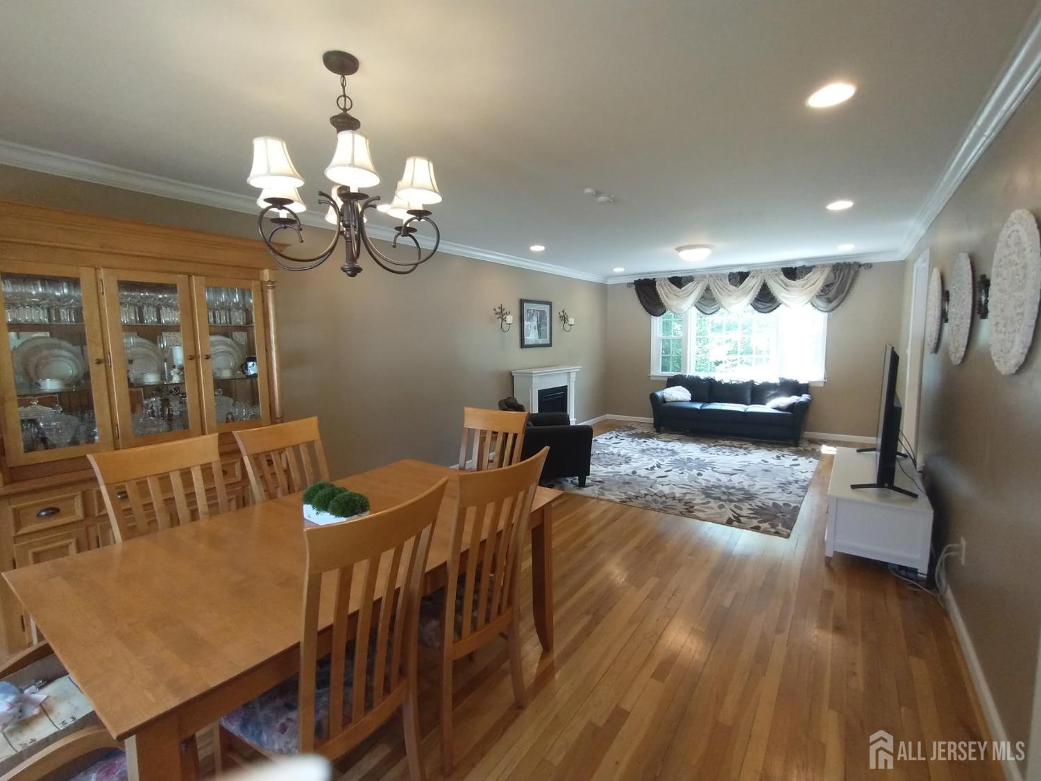 18 Timber Road East Brunswick, NJ 08816 - Photo 8 of 38 a view of a dining room with furniture a chandelier and wooden floor