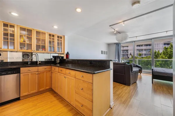 a kitchen with stainless steel appliances granite countertop a stove and a sink