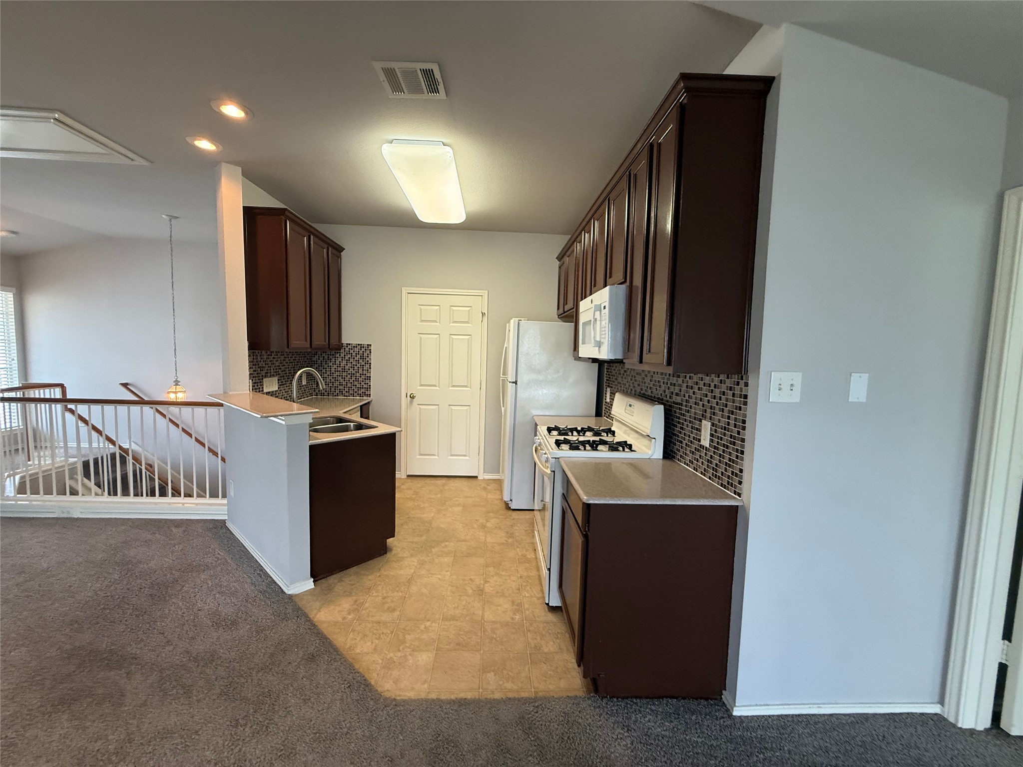 1900 Scofield Ridge Parkway, Unit 4701 Austin, TX 78727 - Photo 4 of 27 Functional kitchen with ample cabinetry and a convenient breakfast bar offers a welcoming atmosphere.
