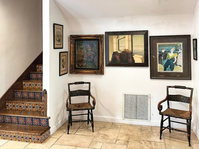 a dining room with furniture a chandelier and window