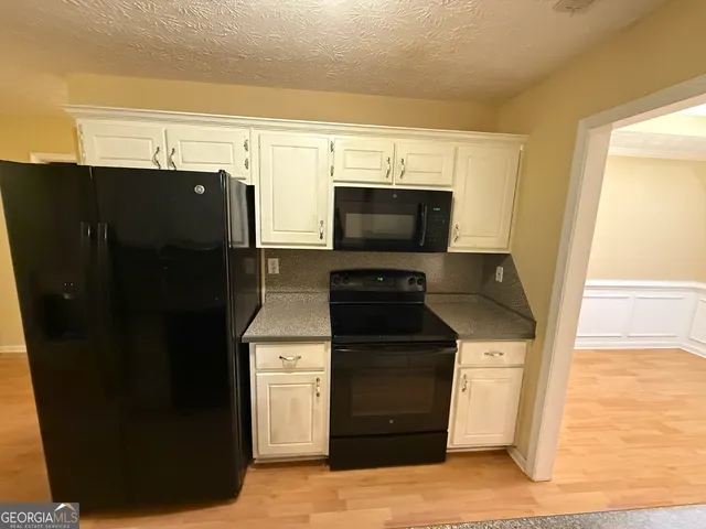 a kitchen with a sink and a refrigerator