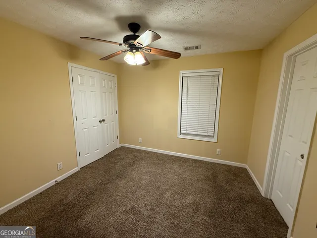 a view of room with window and ceiling fan