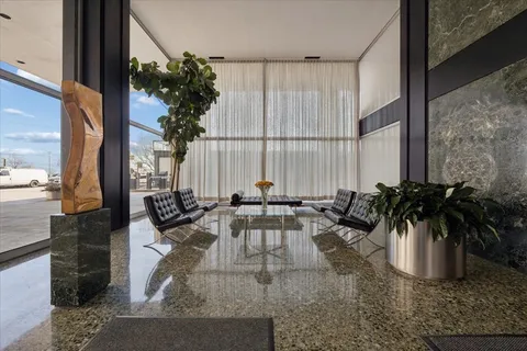 a view of a balcony with chairs and potted plant