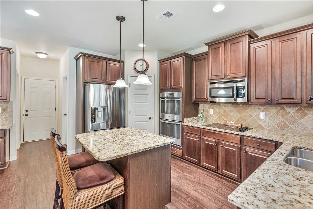 144 Buckland Drive Anderson, SC 29621 - Photo 34 of 48 Prepare meals effortlessly in a well-equipped kitchen featuring abundant cabinetry and a central island with bar seating.