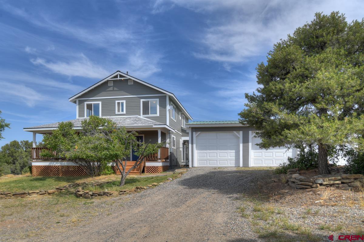 177 Sundance Hills Road Durango, CO 81303 - Photo 1 of 35 a front view of a house with a garden