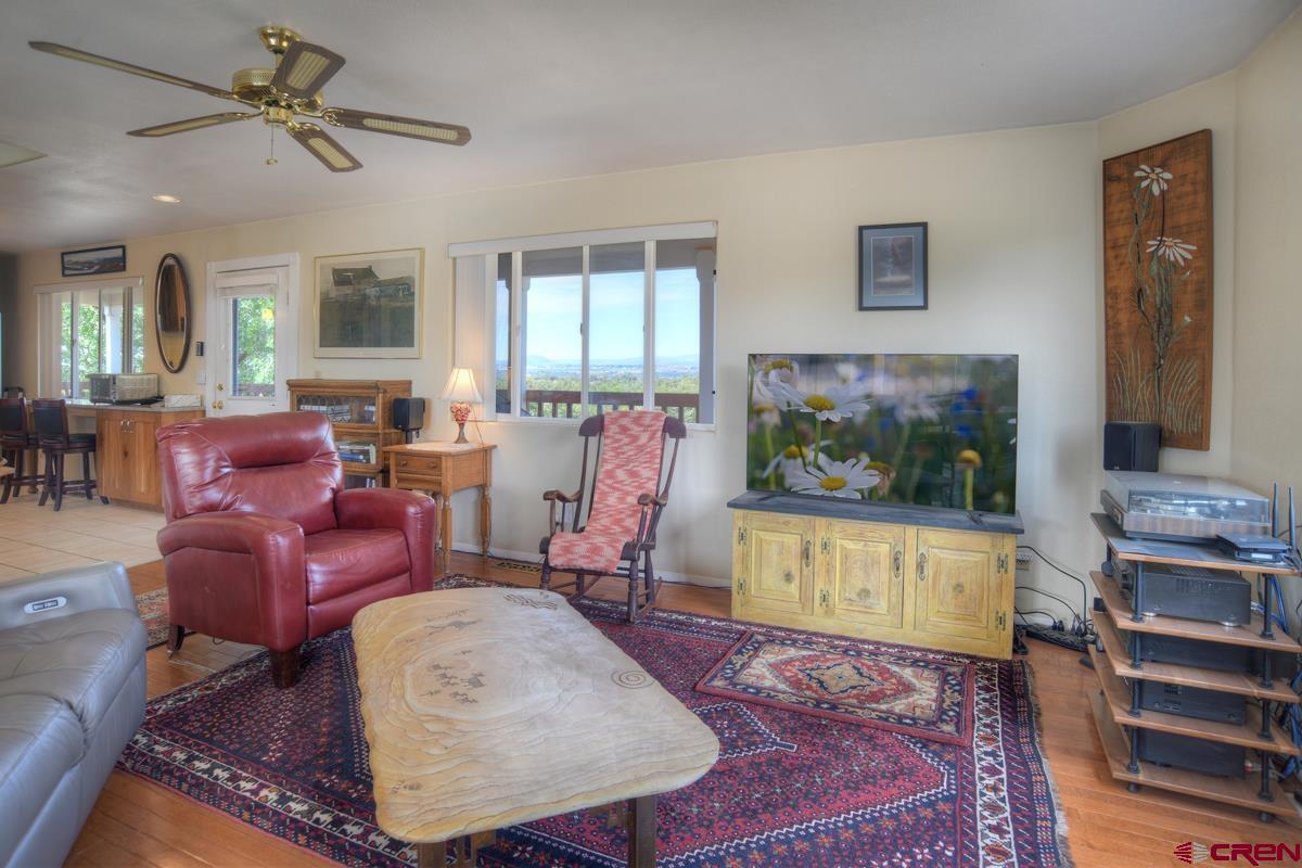 177 Sundance Hills Road Durango, CO 81303 - Photo 11 of 35 a living room with furniture a flat screen tv and a fireplace