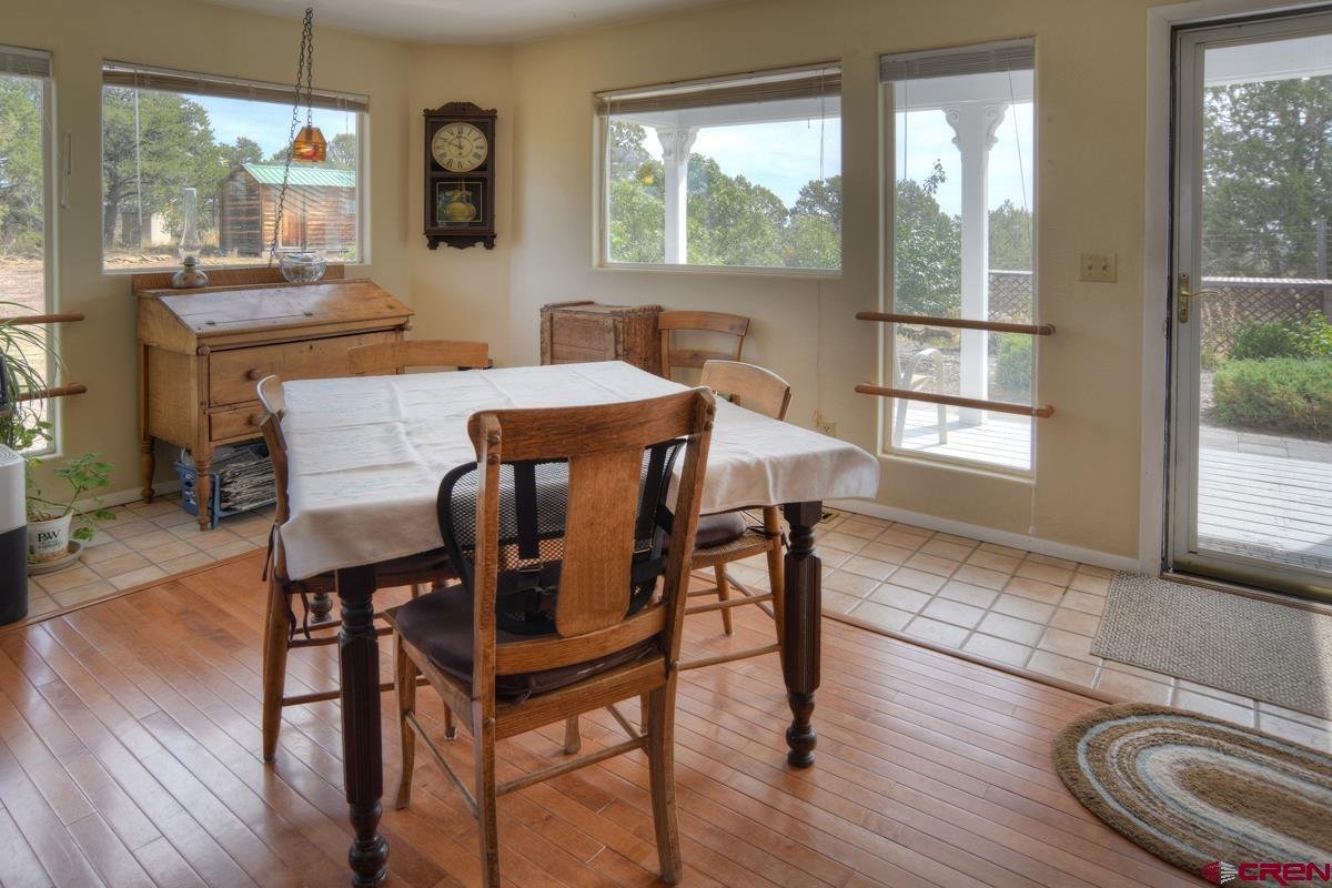 177 Sundance Hills Road Durango, CO 81303 - Photo 14 of 35 a view of a dining room with furniture and wooden floor