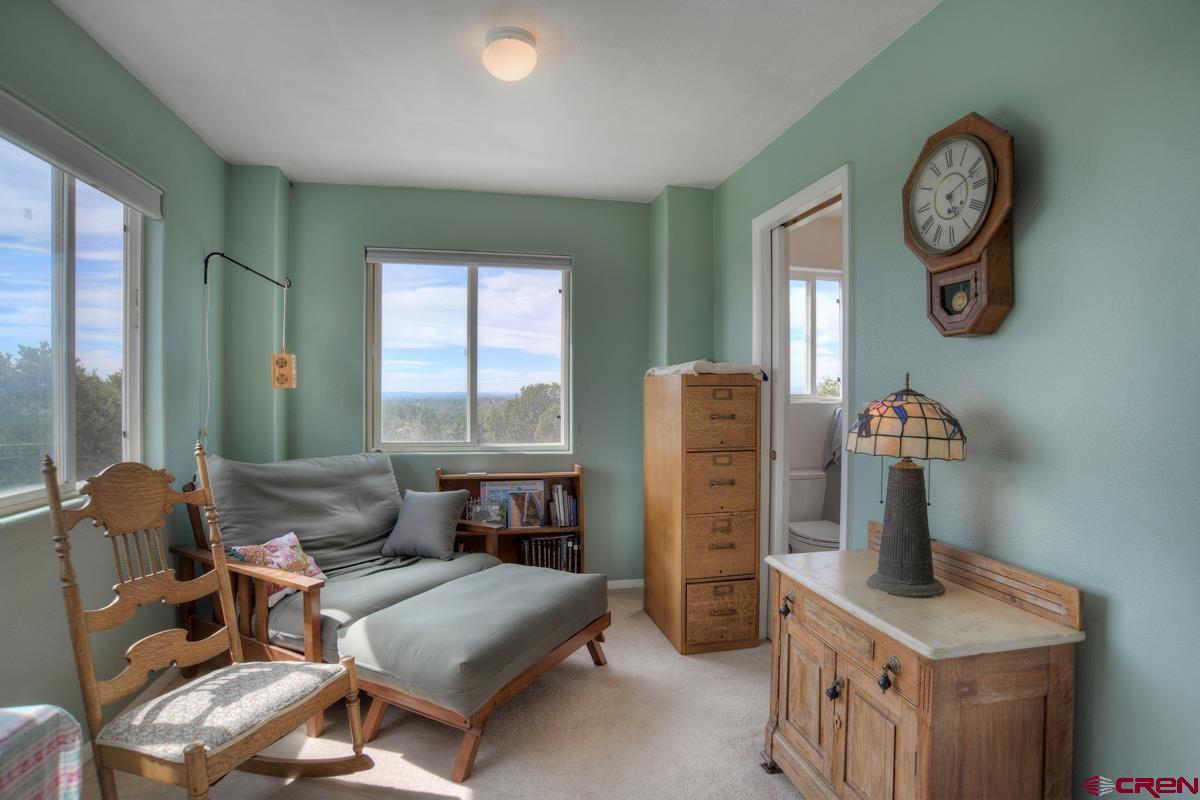 177 Sundance Hills Road Durango, CO 81303 - Photo 15 of 35 a living room with furniture a clock and a window