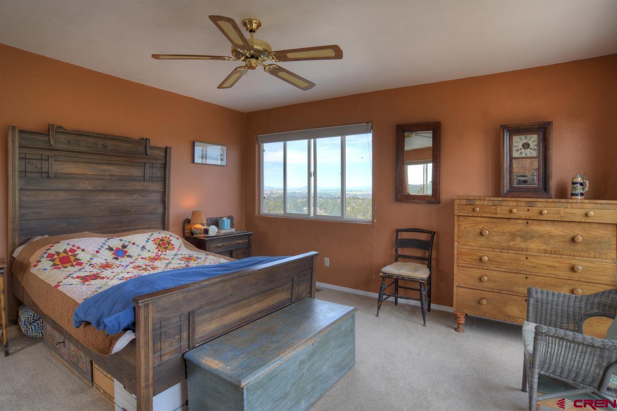 177 Sundance Hills Road Durango, CO 81303 - Photo 17 of 35 a bedroom with a bed and a table in it