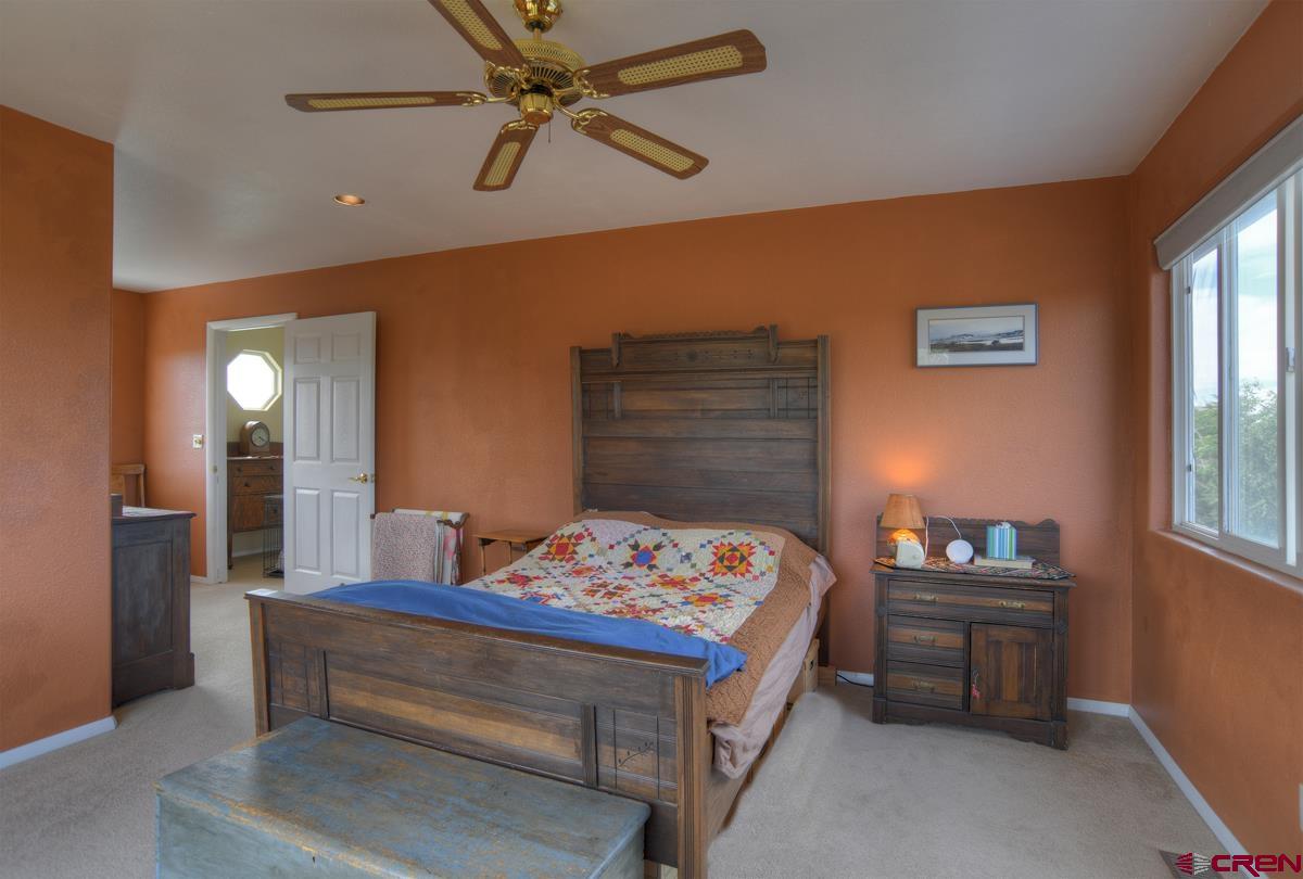 177 Sundance Hills Road Durango, CO 81303 - Photo 18 of 35 a bedroom with a bed and a table