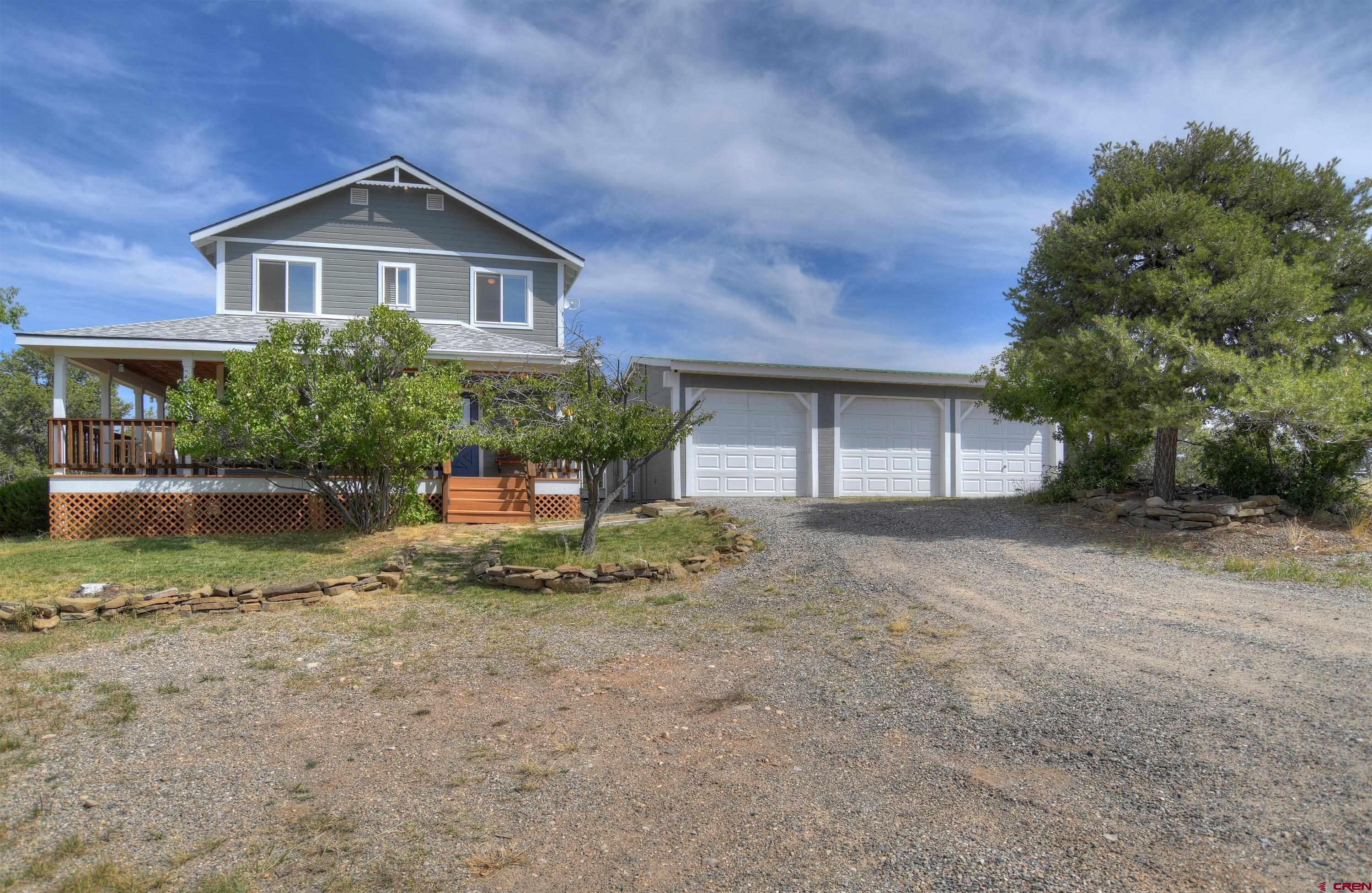 177 Sundance Hills Road Durango, CO 81303 - Photo 2 of 35 a front view of a house with a yard and garage