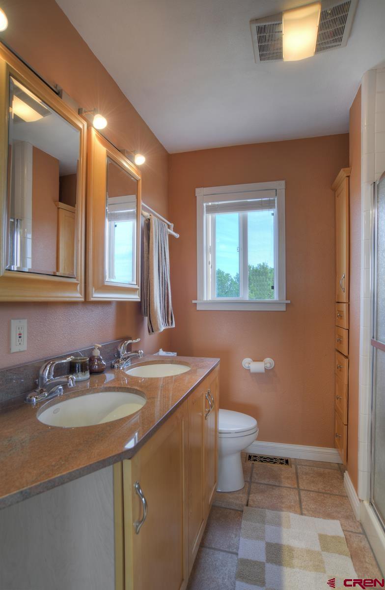 177 Sundance Hills Road Durango, CO 81303 - Photo 21 of 35 a bathroom with a sink toilet and mirror