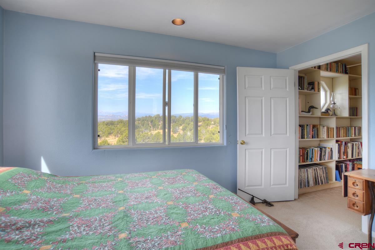 177 Sundance Hills Road Durango, CO 81303 - Photo 23 of 35 a bedroom with a bed and a window