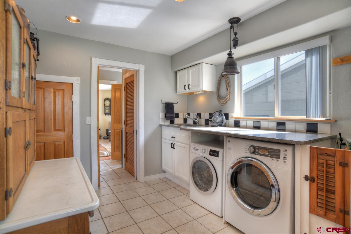 177 Sundance Hills Road Durango, CO 81303 - Photo 25 of 35 a utility room with sink dryer and washer