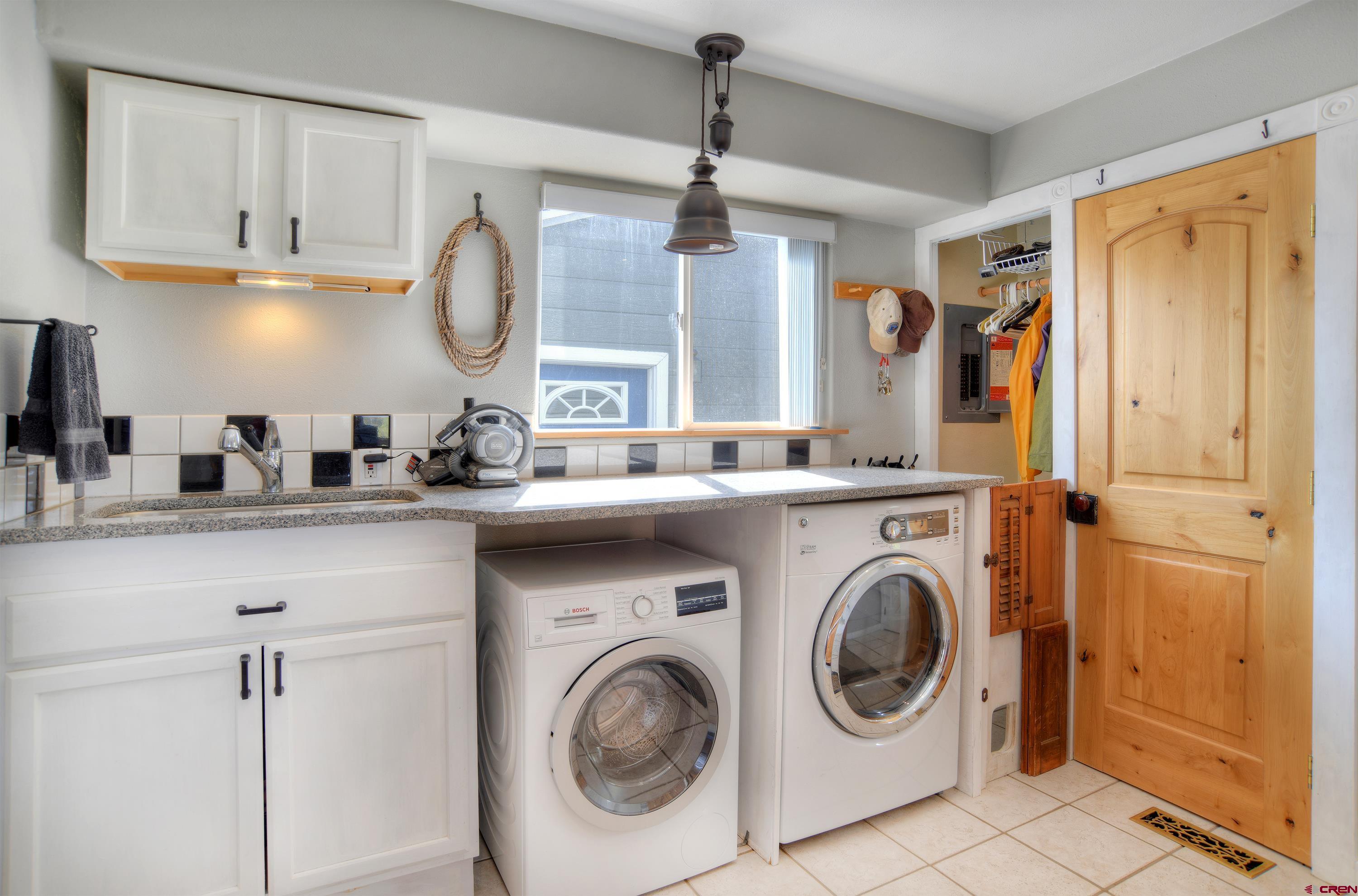 177 Sundance Hills Road Durango, CO 81303 - Photo 26 of 35 a kitchen with stainless steel appliances white cabinets and a sink