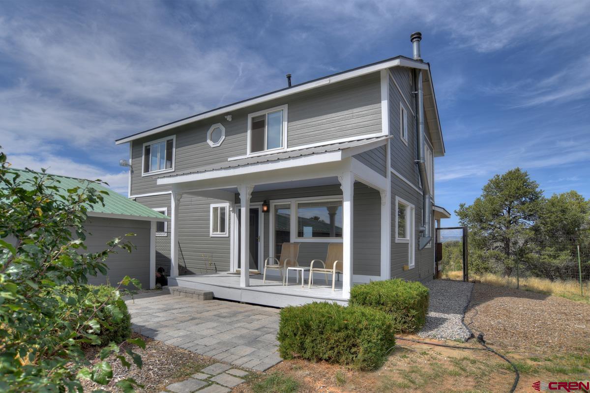 177 Sundance Hills Road Durango, CO 81303 - Photo 3 of 35 a front view of a house with a yard outdoor seating and plants