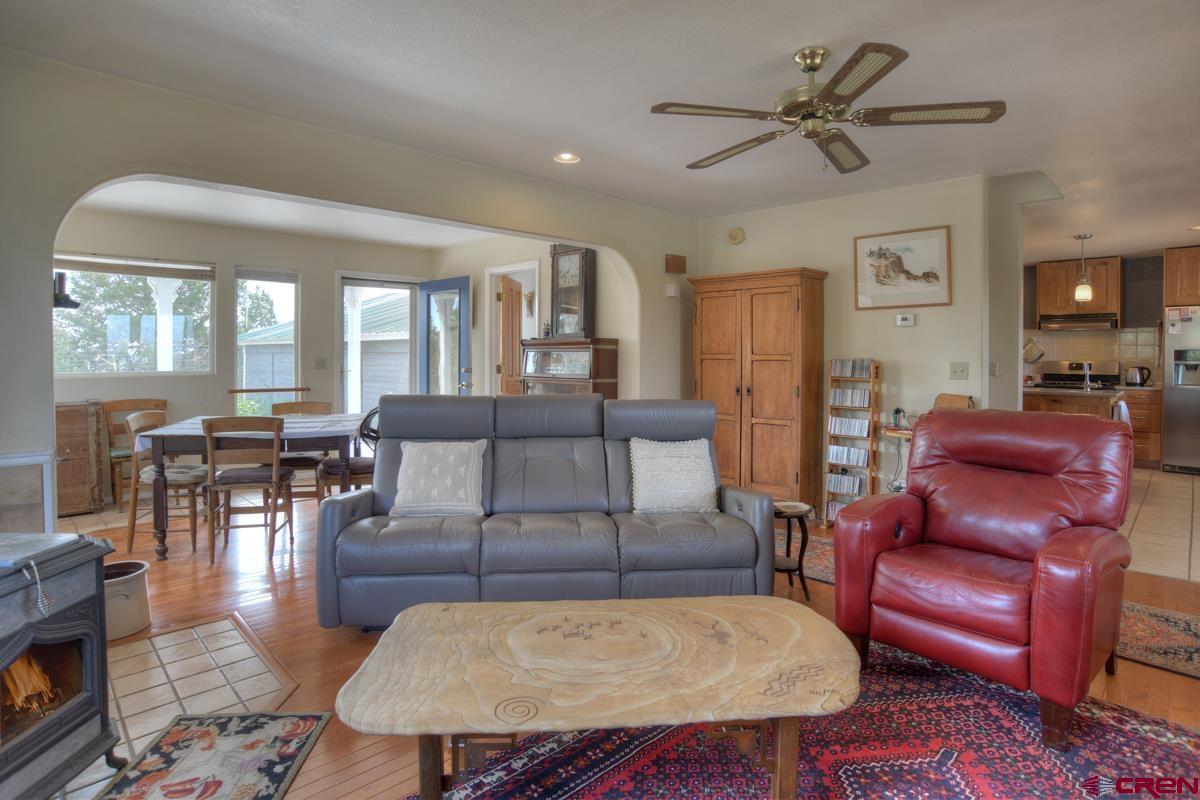 177 Sundance Hills Road Durango, CO 81303 - Photo 10 of 35 a living room with furniture a wooden floor and a chandelier