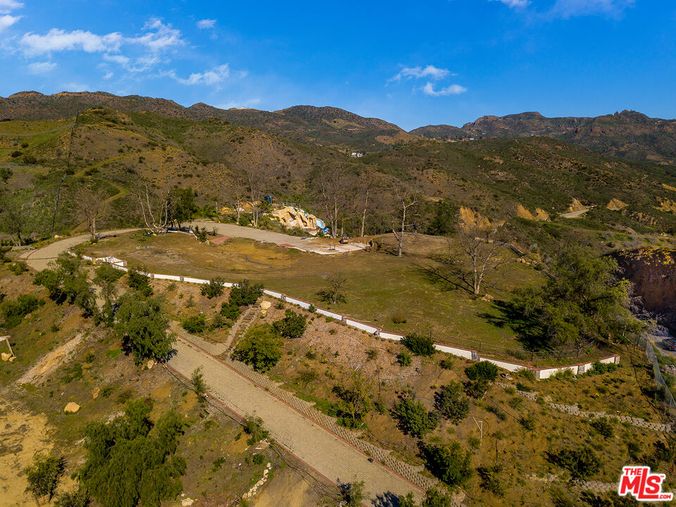 1665 Encinal Canyon Road Malibu, CA 90265 - Photo 12 of 15 a view of a backyard of a house with a mountain