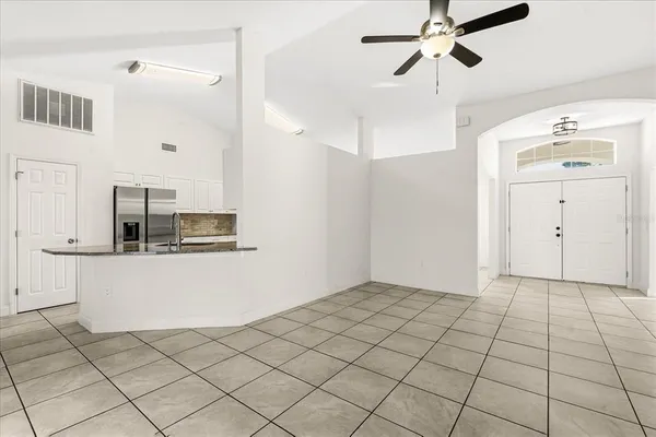 a view of kitchen with refrigerator and window