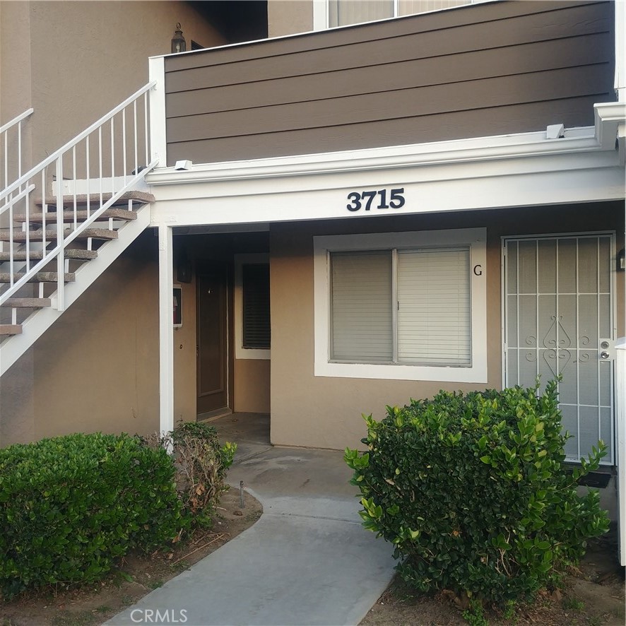 a front view of a house with plants