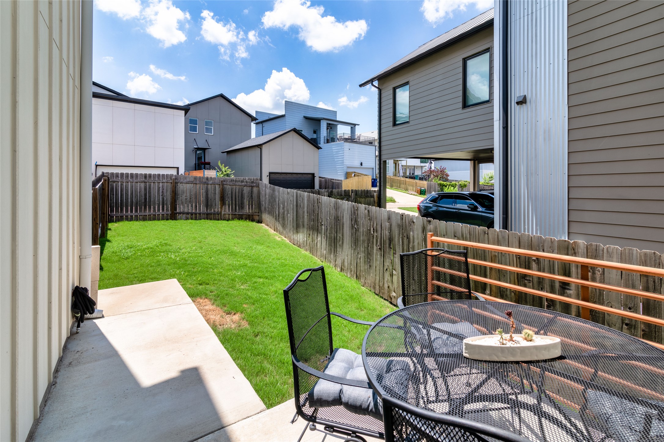 6025 Seville Drive Austin, TX 78724 - Photo 32 of 40 Private backyard featuring a concrete patio, a manicured lawn, and a perimeter wood fence
