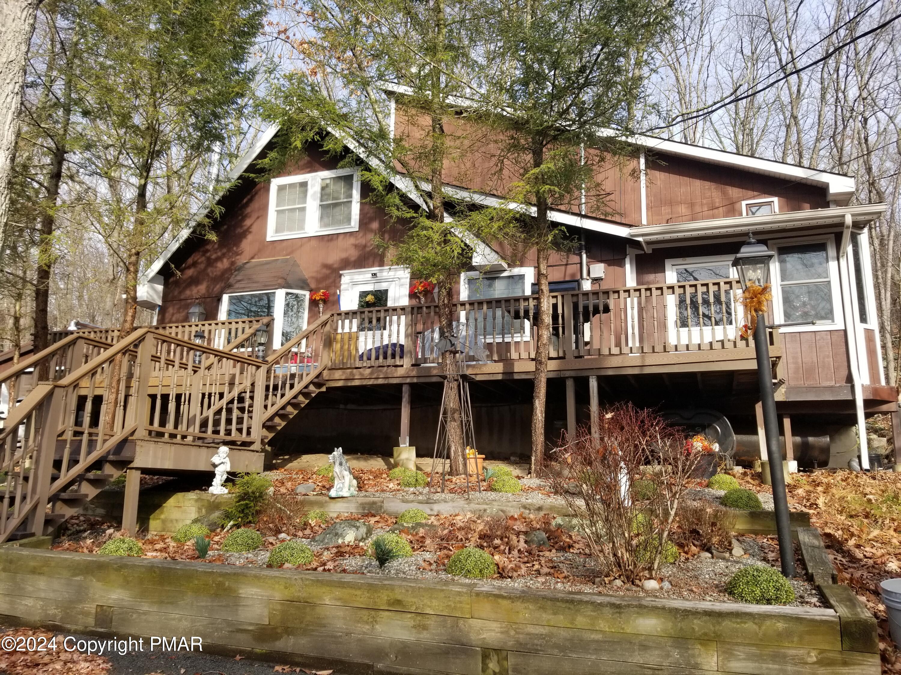 6349 Decker Road Bushkill, PA 18324 - Photo 1 of 28 a front view of a house with swimming pool