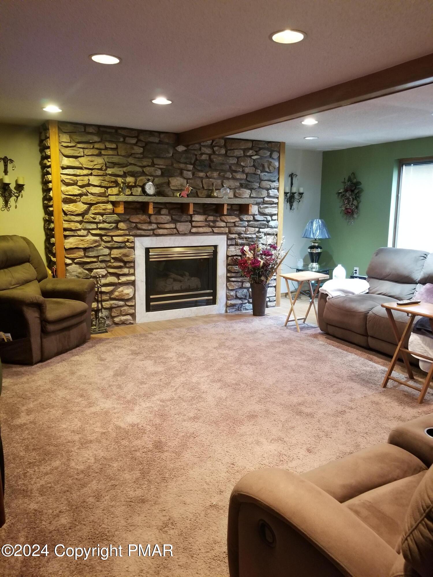 6349 Decker Road Bushkill, PA 18324 - Photo 11 of 28 a living room with furniture a fireplace and a flat screen tv