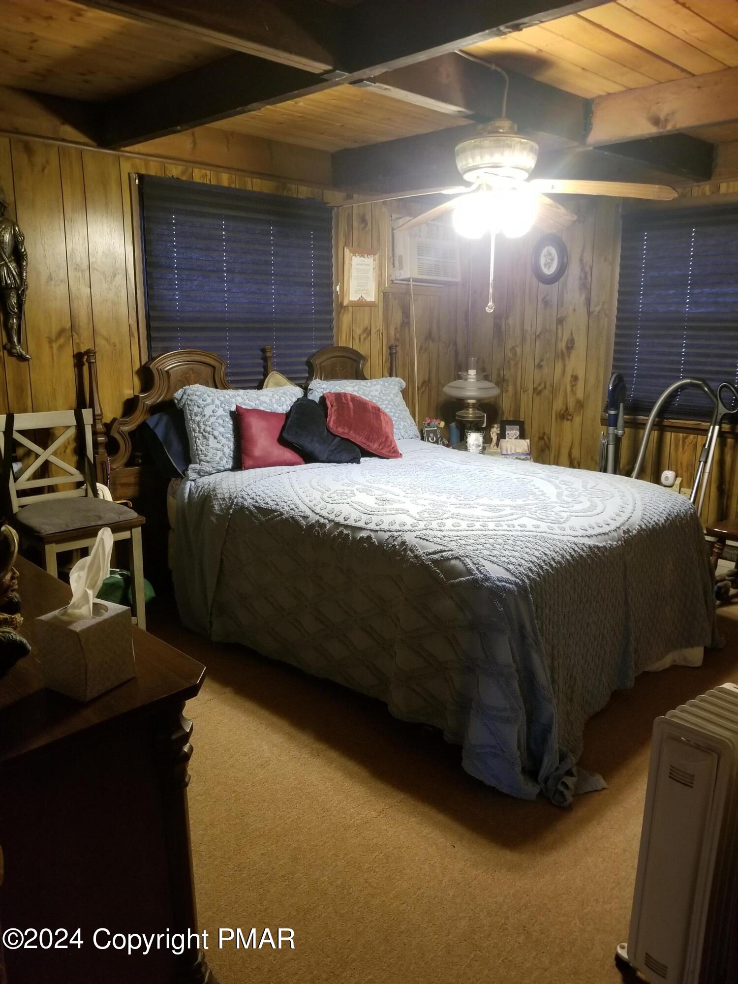 6349 Decker Road Bushkill, PA 18324 - Photo 12 of 28 a spacious bedroom with a bed and a large mirror