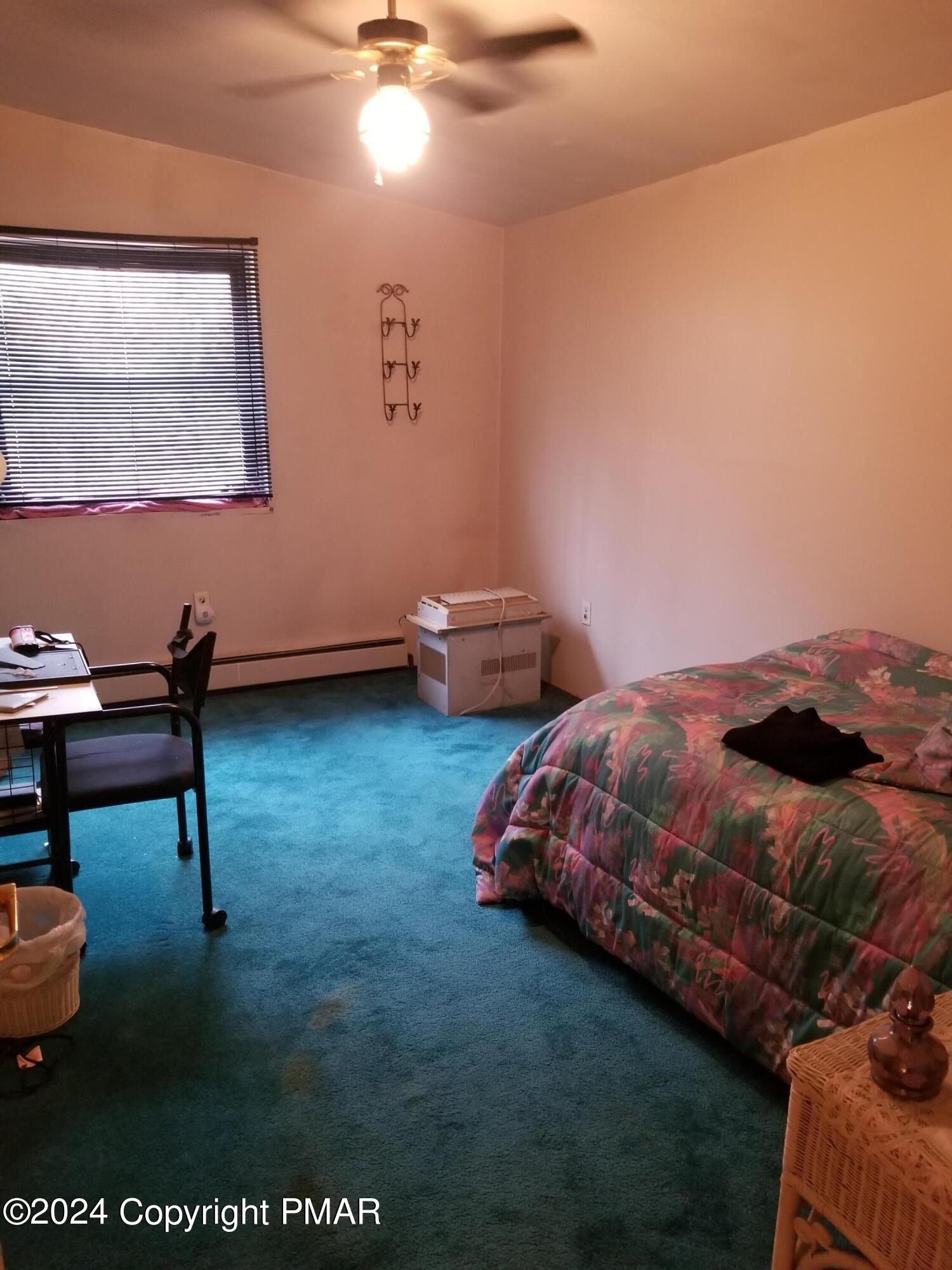 6349 Decker Road Bushkill, PA 18324 - Photo 18 of 28 a bedroom with a bed and a chair