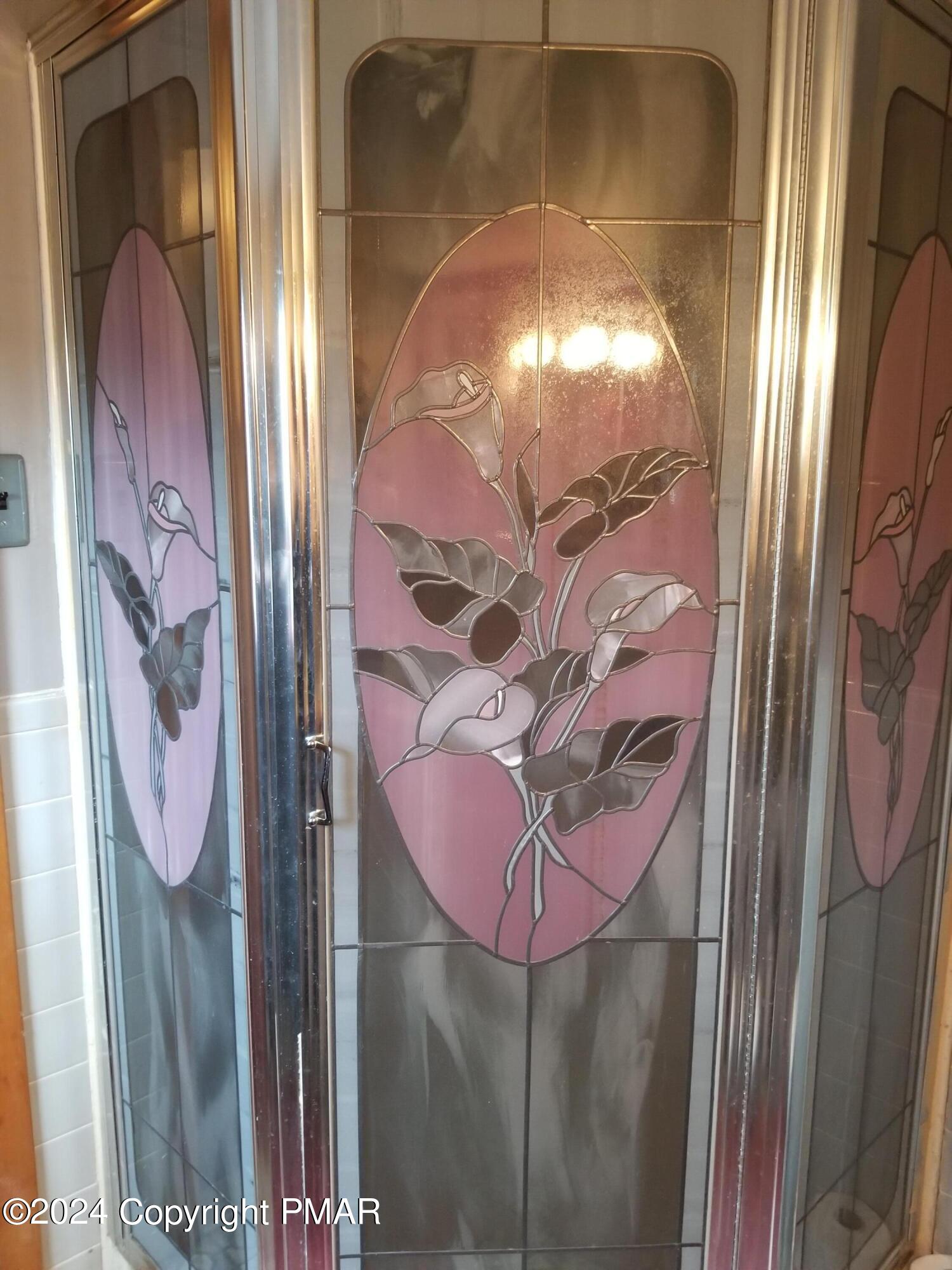 6349 Decker Road Bushkill, PA 18324 - Photo 22 of 28 a bathroom with a mirror and a shower curtain