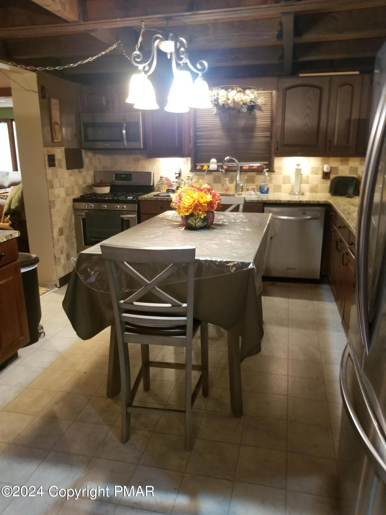 6349 Decker Road Bushkill, PA 18324 - Photo 5 of 28 a kitchen with a sink cabinets and appliances