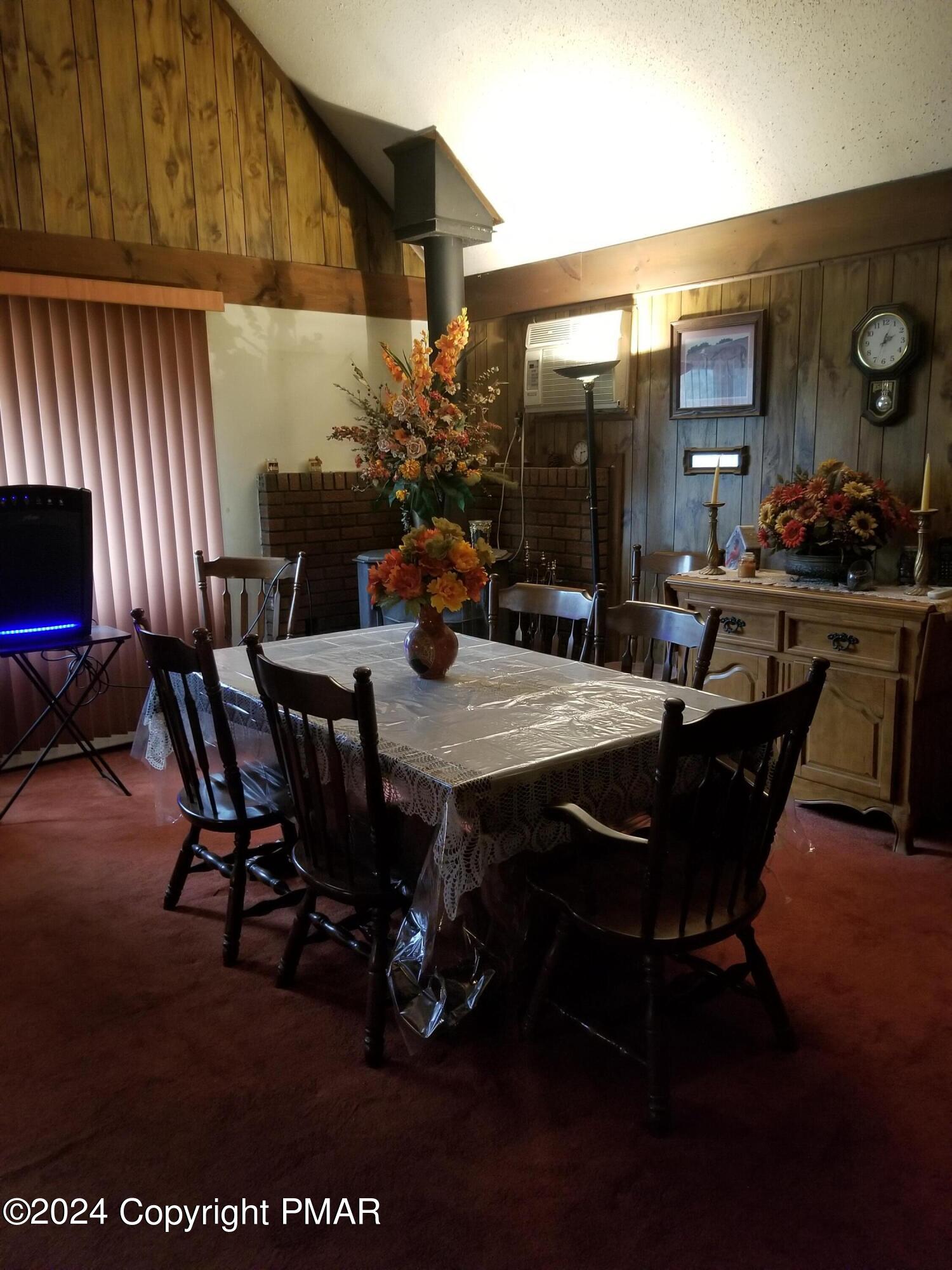 6349 Decker Road Bushkill, PA 18324 - Photo 9 of 28 a view of a dining room with furniture and wooden floor