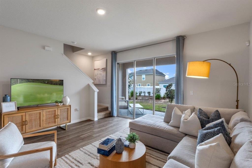 2729 Gladiola Road Winter Haven, FL 33884 - Photo 11 of 25 a living room with furniture and a flat screen tv