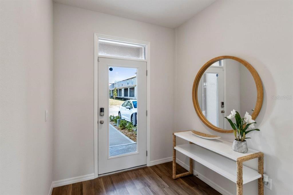 2729 Gladiola Road Winter Haven, FL 33884 - Photo 2 of 25 a room with painting on the wall and a potted plant