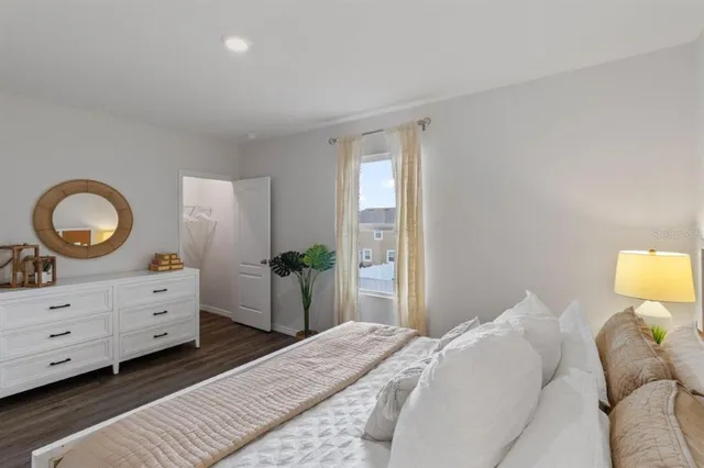 a bedroom with a bed and a dresser