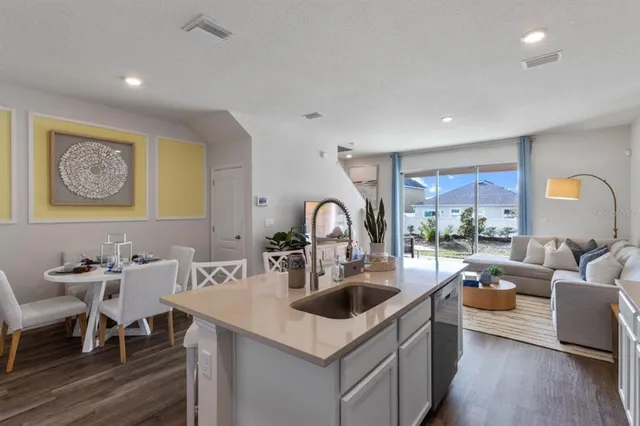 a kitchen with a sink cabinets and wooden floor