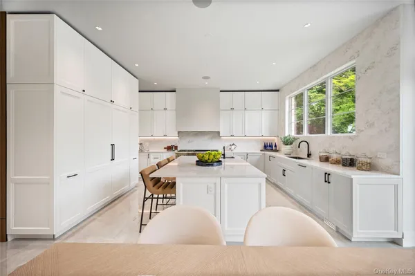 a kitchen with a sink a window and stainless steel appliances