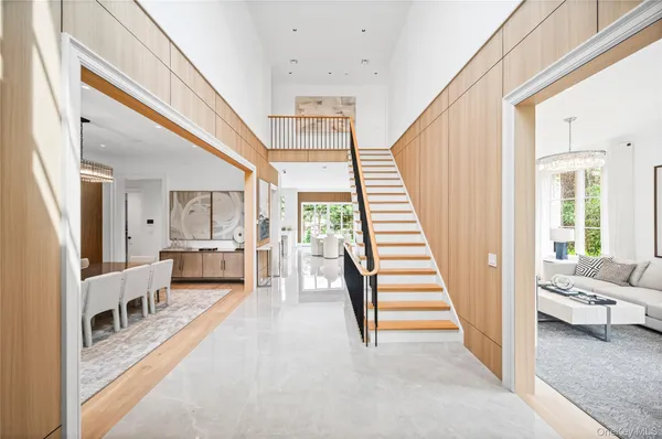 a view of a livingroom with furniture and stairs