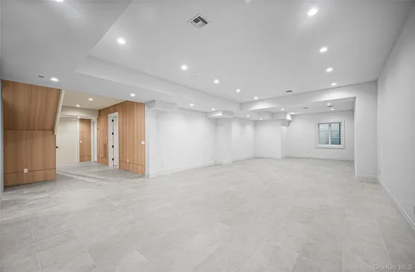 an empty room with windows and pillars in it
