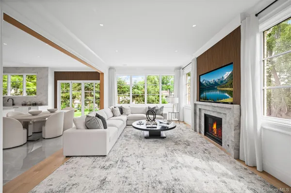 a living room with furniture a flat screen tv and a fireplace