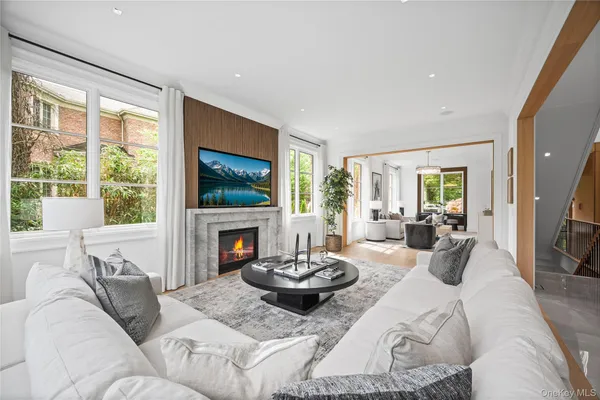 a living room with furniture a flat screen tv and a fireplace