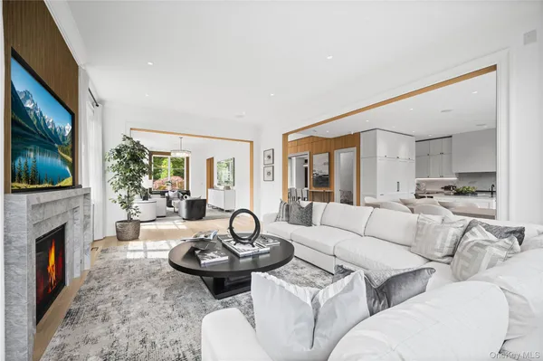 a living room with furniture a fireplace and a flat screen tv