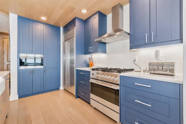 a large kitchen with stainless steel appliances granite countertop a stove and a sink