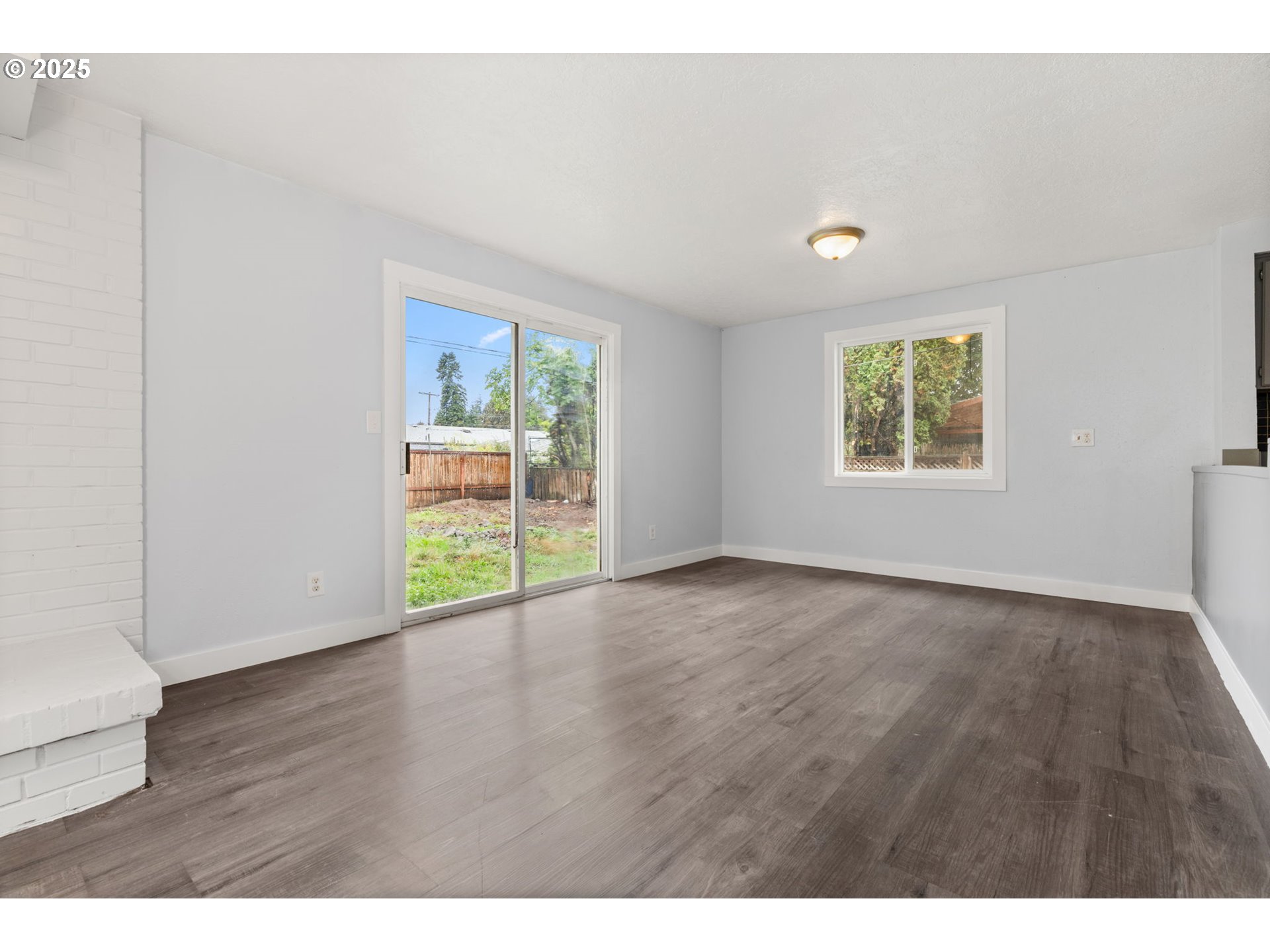 1203 Northeast 190th Place Portland, OR 97230 - Photo 13 of 48 a view of an empty room with wooden floor and a window