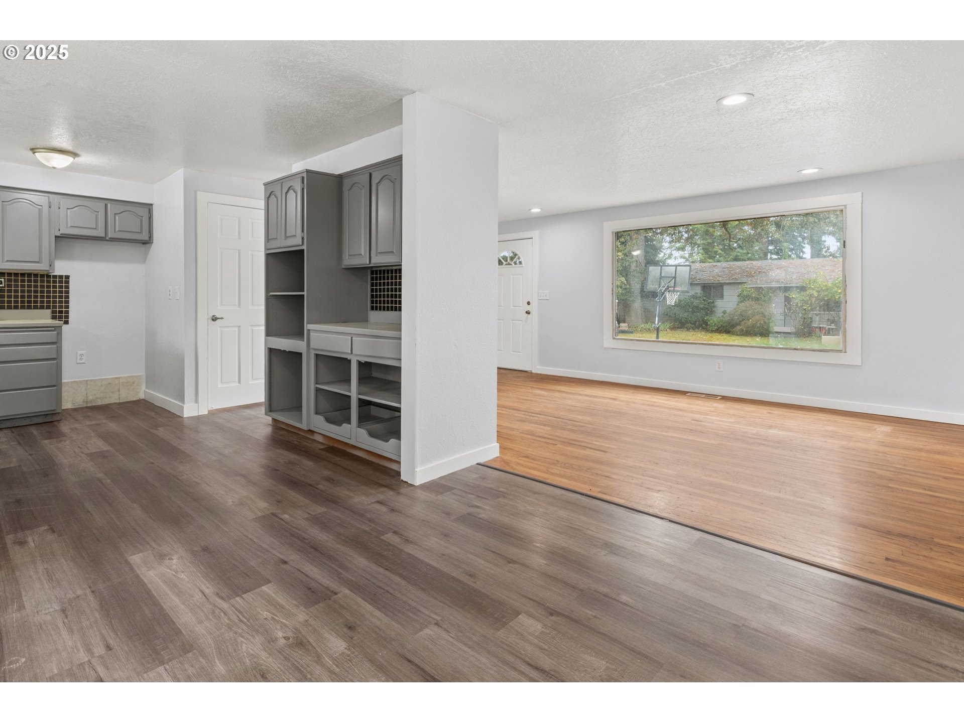 1203 Northeast 190th Place Portland, OR 97230 - Photo 18 of 48 a view of an empty room with a window and wooden floor