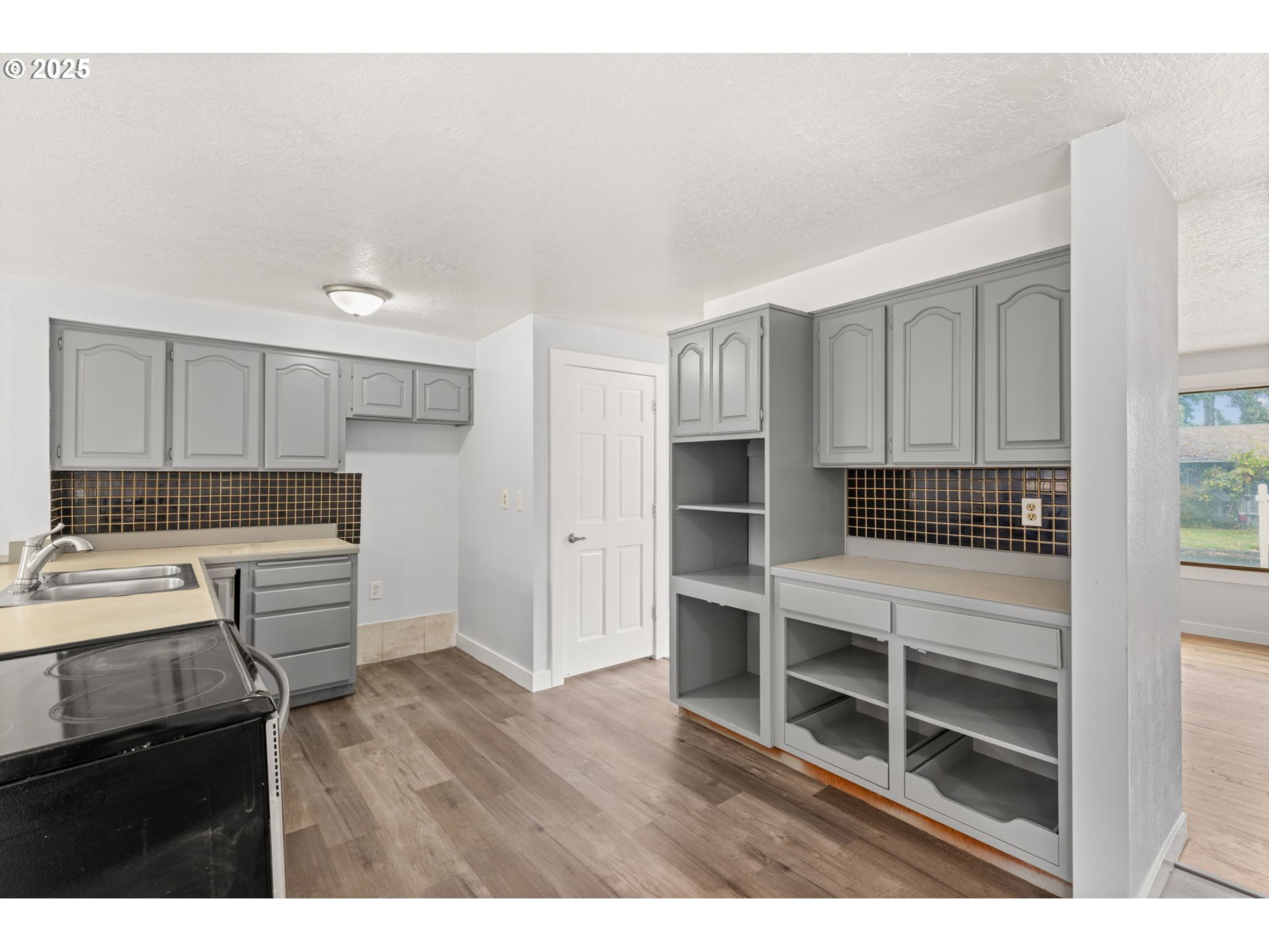 1203 Northeast 190th Place Portland, OR 97230 - Photo 20 of 48 a kitchen with a refrigerator and a stove top oven
