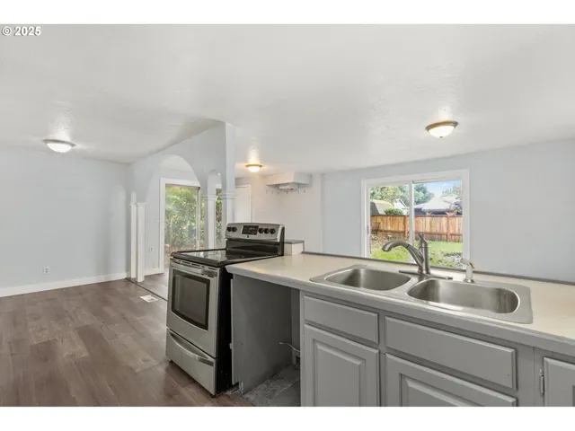 a kitchen with a sink cabinets and window