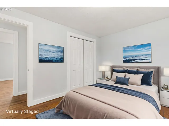 a bedroom with a bed and a painting on the wall