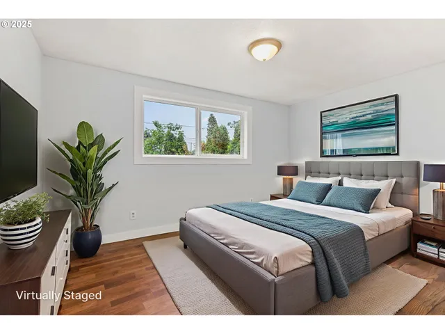 a bedroom with bed and a potted plant