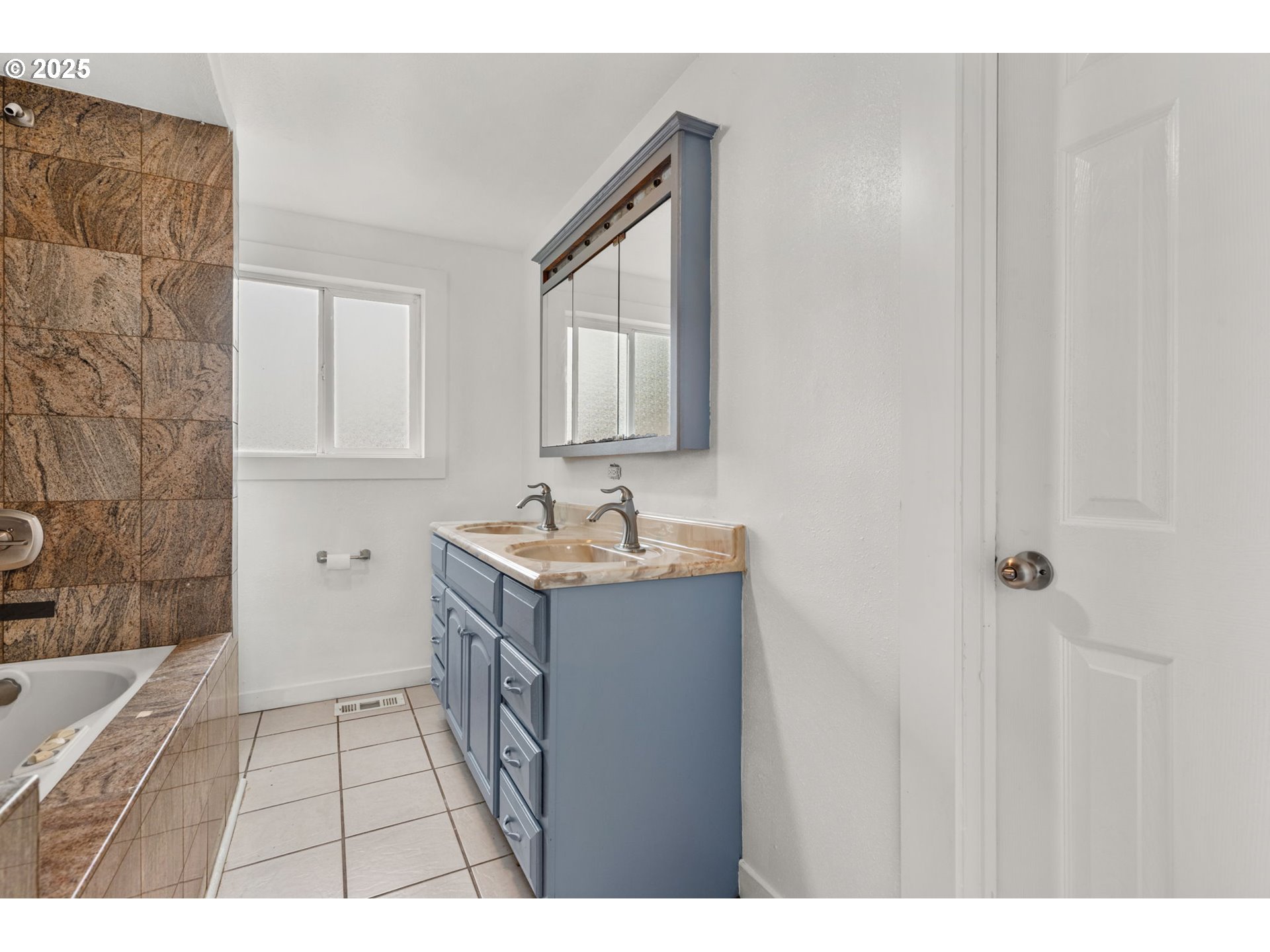 1203 Northeast 190th Place Portland, OR 97230 - Photo 29 of 48 a bathroom with a sink a mirror and a bathtub